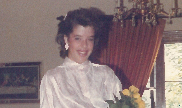 old picture of woman at home holding flowers