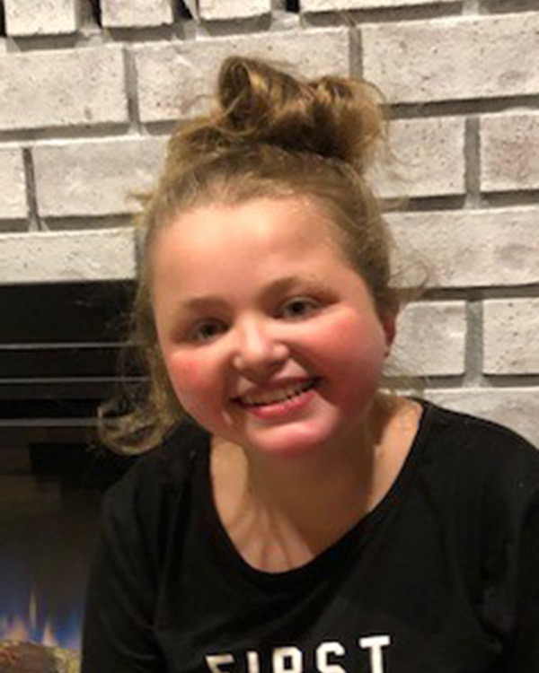 smiling child at home by fireplace
