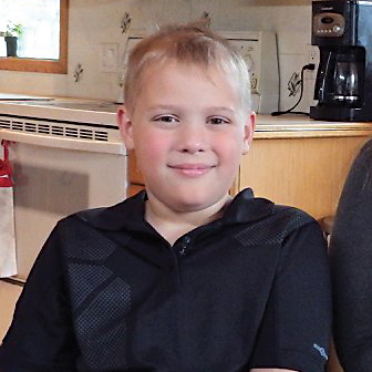 blonde child at home in his kitchen