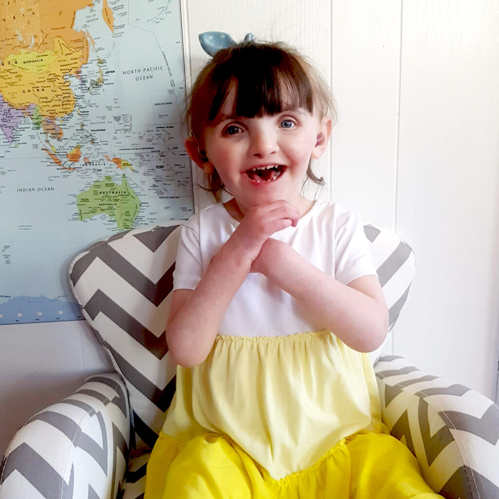 laughing child in yellow dress