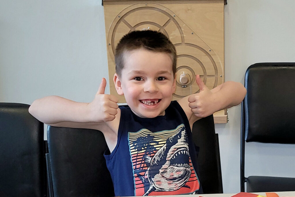 Child giving two thumbs up