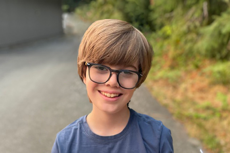 child with glasses smiling