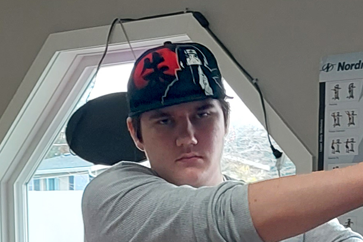 youth with ball cap on at physiotherapists